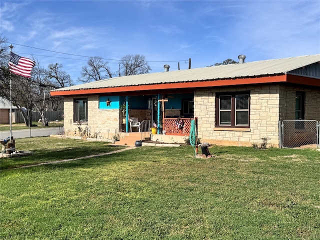 rear view of property featuring a lawn