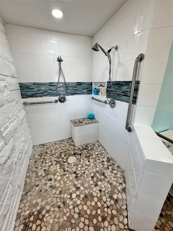 bathroom with a tile shower