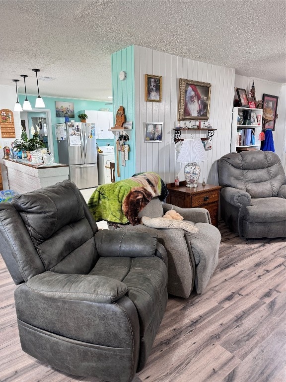 living room featuring a textured ceiling and wood-type flooring