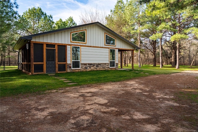 back of house with a lawn