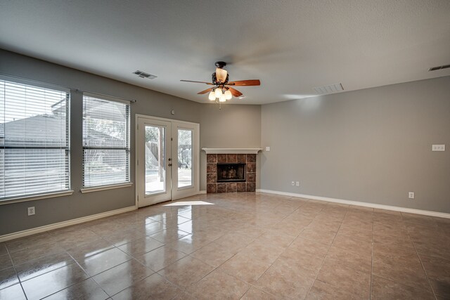 kitchen featuring ceiling fan, a fireplace, a kitchen island, backsplash, and stainless steel appliances