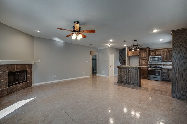 tiled empty room with ceiling fan and ornamental molding