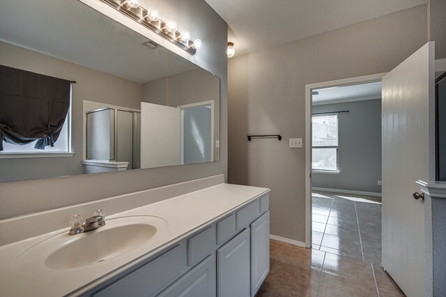 bathroom featuring shower with separate bathtub, vanity, and tile patterned flooring