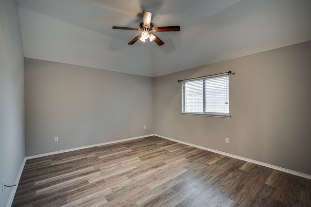 bedroom with ceiling fan and tile walls