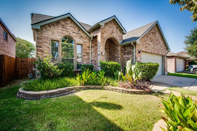 front facade featuring a garage and a front lawn