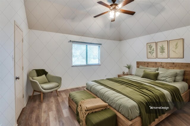 spare room featuring ceiling fan, vaulted ceiling, and wood-type flooring