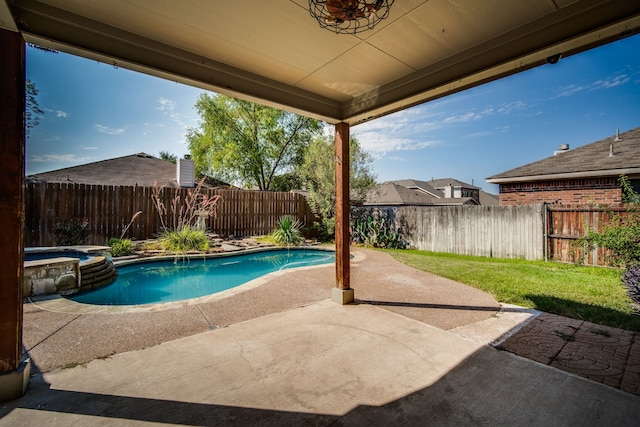 back of property with a patio area, a fenced in pool, a yard, and a storage unit