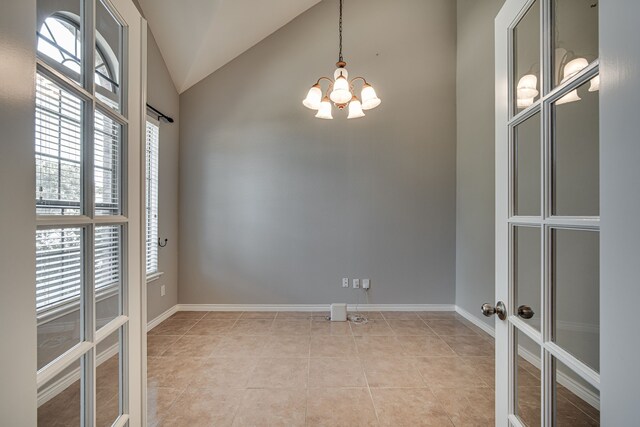 office space with vaulted ceiling, a notable chandelier, and tile patterned floors