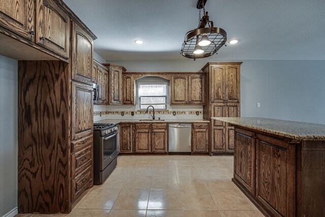 kitchen with sink, decorative light fixtures, light tile patterned floors, a kitchen island, and stainless steel appliances