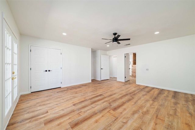 unfurnished bedroom with ceiling fan and light hardwood / wood-style floors