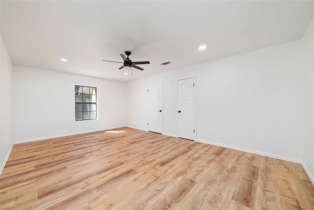 unfurnished room with light wood-type flooring and ceiling fan