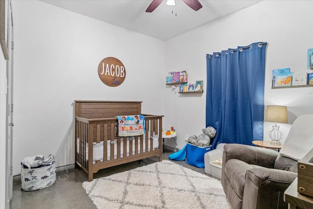 bedroom with a nursery area and ceiling fan