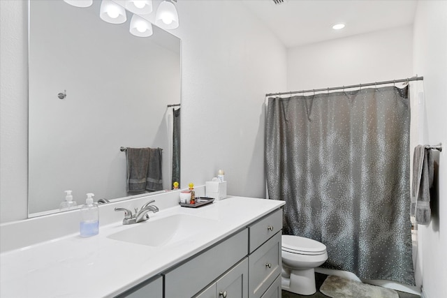 bathroom featuring toilet and vanity with extensive cabinet space