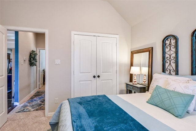 carpeted bedroom featuring a closet and vaulted ceiling