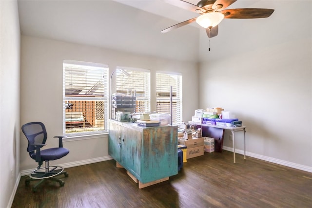 office space featuring a healthy amount of sunlight, ceiling fan, and dark hardwood / wood-style floors