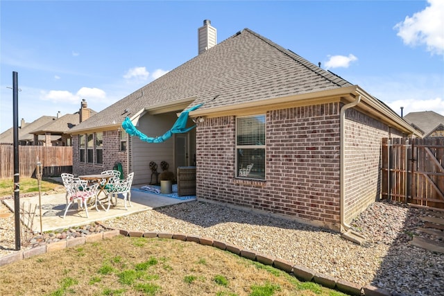 back of property with a patio