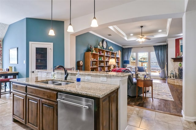 kitchen featuring stainless steel dishwasher, ceiling fan, light tile floors, and dark brown cabinets