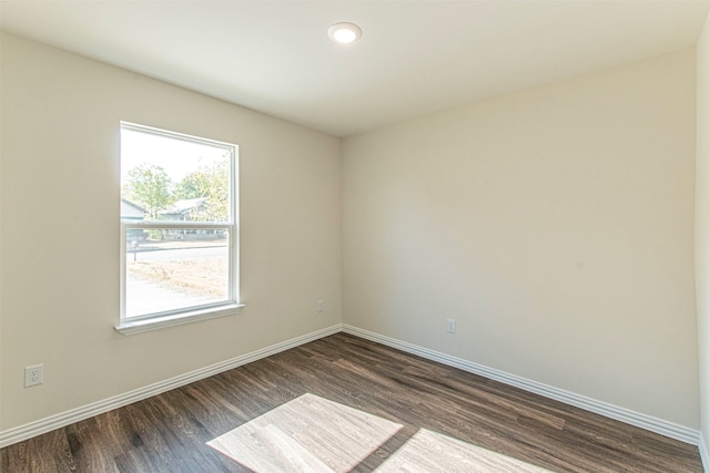 spare room with dark hardwood / wood-style flooring