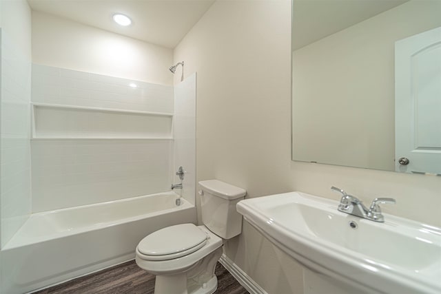 full bathroom featuring wood-type flooring, bathtub / shower combination, toilet, and sink