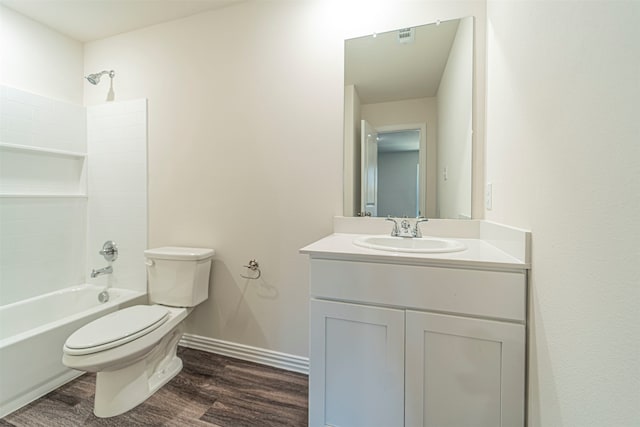 full bathroom with vanity, washtub / shower combination, toilet, and hardwood / wood-style floors