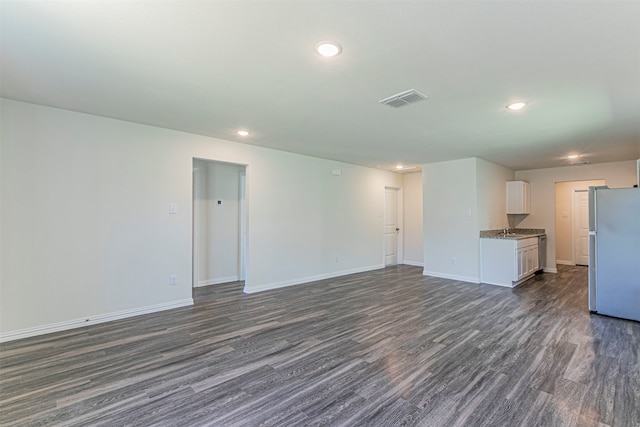 unfurnished living room featuring dark hardwood / wood-style floors