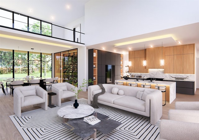 living room with light hardwood / wood-style flooring, a high ceiling, and sink