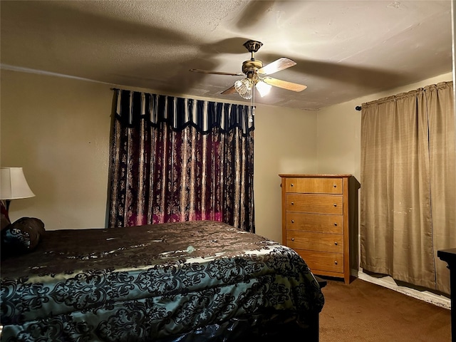 bedroom with dark carpet, ceiling fan, and a textured ceiling