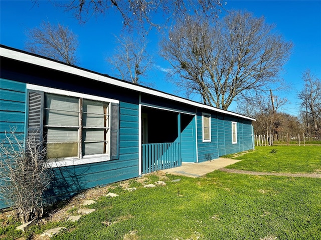 view of home's exterior with a yard