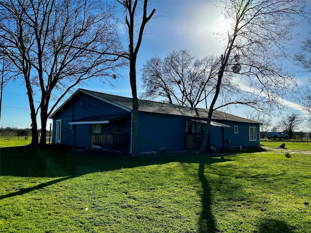 rear view of house featuring a lawn