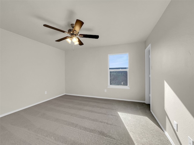 unfurnished room featuring ceiling fan and carpet