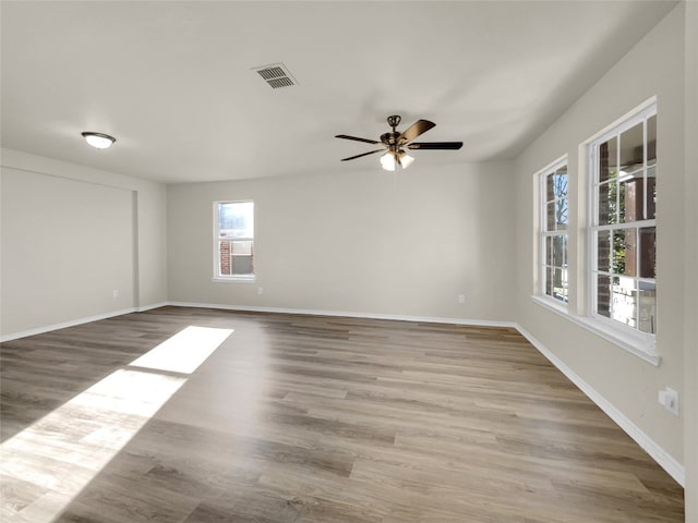 spare room featuring ceiling fan and light hardwood / wood-style floors