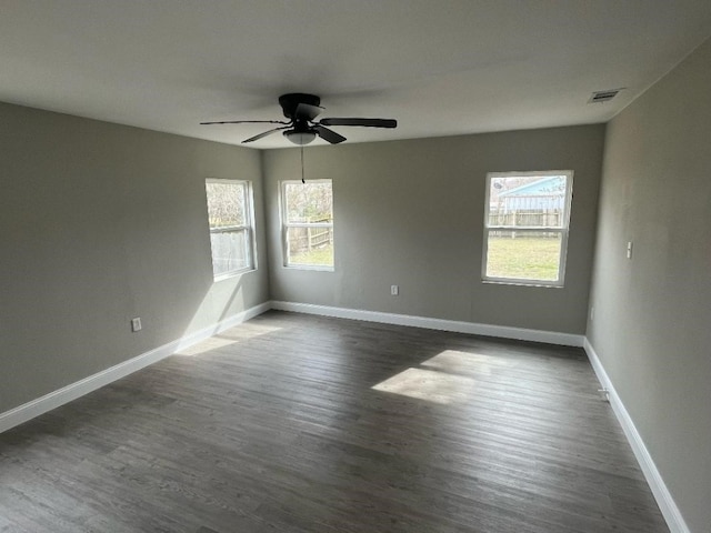 spare room featuring dark hardwood / wood-style flooring and ceiling fan