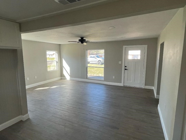 spare room with ceiling fan and dark wood-type flooring