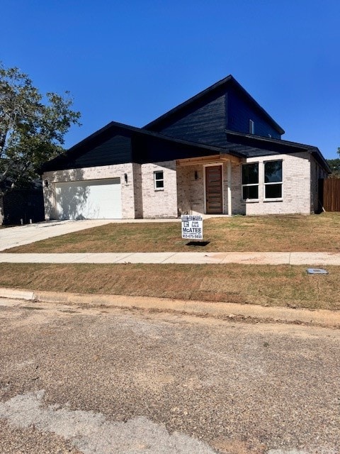 view of front of house with a front lawn and a garage