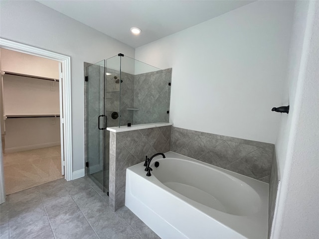 bathroom featuring separate shower and tub and tile patterned flooring