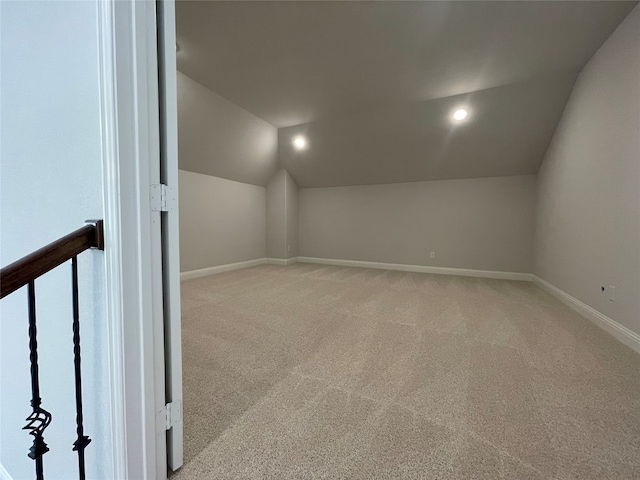 additional living space with light colored carpet and lofted ceiling