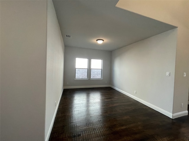 spare room featuring dark wood-type flooring