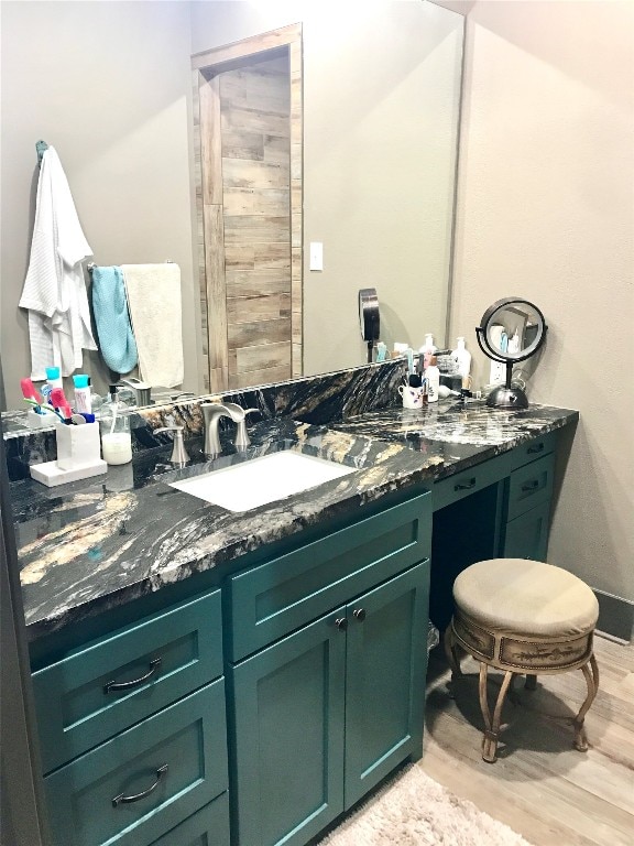 bathroom with vanity and wood-type flooring