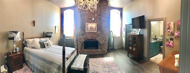 bedroom featuring a notable chandelier, a brick fireplace, multiple windows, and dark hardwood / wood-style floors