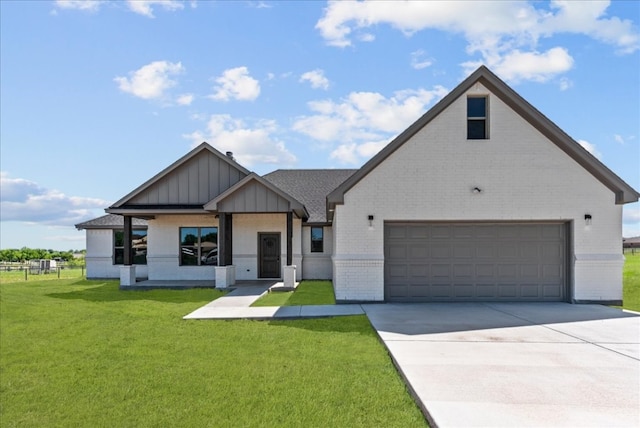 view of front of home with a front lawn and a garage