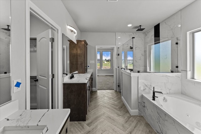 bathroom featuring shower with separate bathtub, vanity, and parquet floors