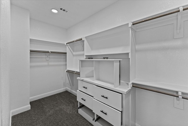 spacious closet featuring dark carpet