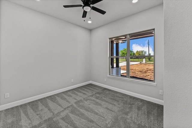 carpeted empty room featuring ceiling fan