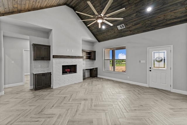 unfurnished living room with wood ceiling, ceiling fan, high vaulted ceiling, and light parquet flooring