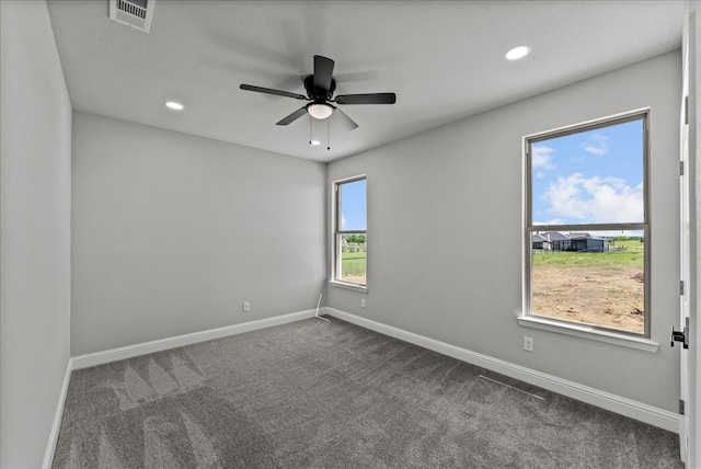 carpeted empty room featuring ceiling fan