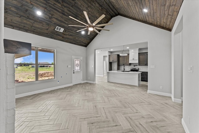 unfurnished living room featuring ceiling fan, high vaulted ceiling, sink, wood ceiling, and light parquet floors