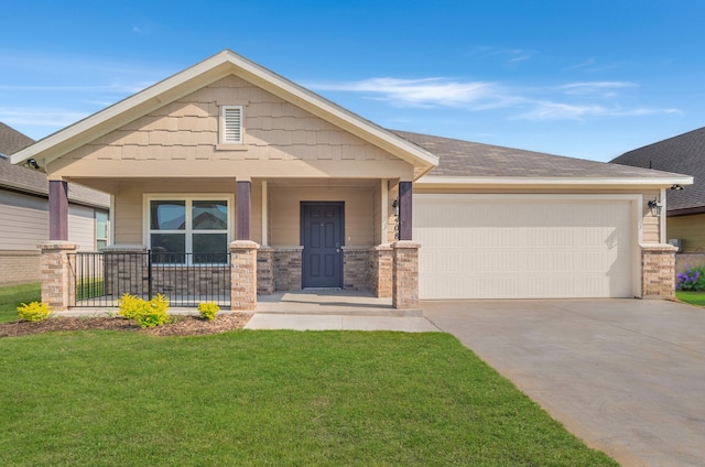 view of front of home with covered porch, a garage, and a front lawn