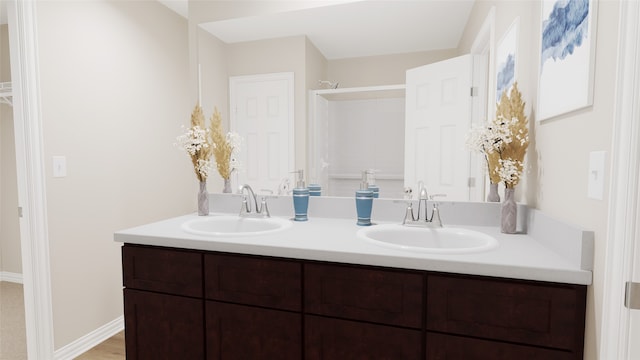 bathroom featuring hardwood / wood-style flooring and dual bowl vanity