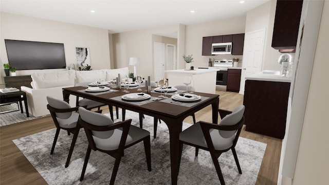 dining space featuring sink and light wood-type flooring