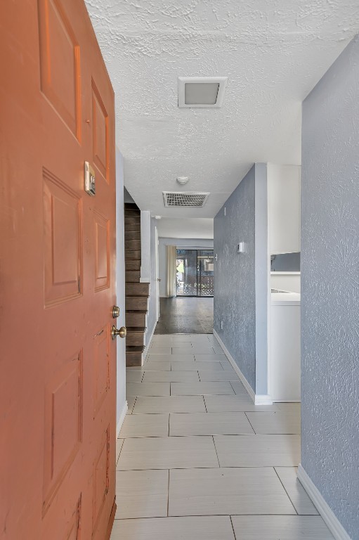 stairway featuring tile patterned floors